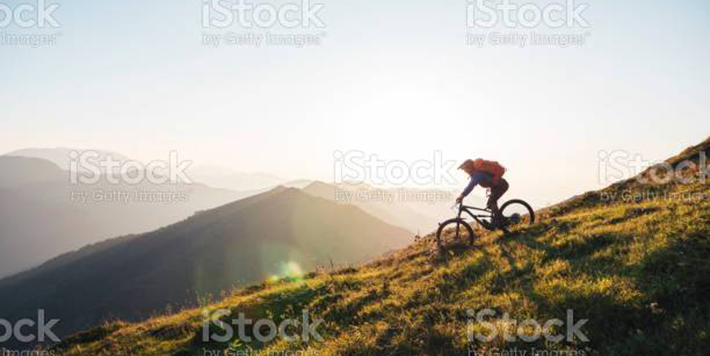Mountain biker riding downhill in the mountains.